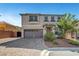 Attractive two-story home featuring a neutral color scheme and beautiful front yard landscaping at 10325 Quartz Reef Ct, Las Vegas, NV 89141