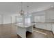 Open kitchen and living area featuring wood look flooring and large windows for ample natural light at 10325 Quartz Reef Ct, Las Vegas, NV 89141