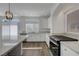 Modern kitchen boasts granite countertops, white cabinetry, and stainless steel appliances including oven at 10325 Quartz Reef Ct, Las Vegas, NV 89141