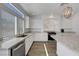 Modern kitchen featuring granite countertops, stainless steel appliances and ample natural light from the window at 10325 Quartz Reef Ct, Las Vegas, NV 89141