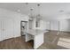 Spacious kitchen features an island with pendant lighting, stainless steel appliances, and wood-look flooring at 10325 Quartz Reef Ct, Las Vegas, NV 89141