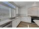 Modern kitchen boasts granite countertops, stainless steel appliances, and ample natural light for cooking at 10325 Quartz Reef Ct, Las Vegas, NV 89141