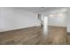 Bright living room with wood-look tile floor and open staircase at 10325 Quartz Reef Ct, Las Vegas, NV 89141