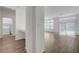 Bright living room with wood-style tile floors and natural light, seamlessly connecting to laundry area at 10325 Quartz Reef Ct, Las Vegas, NV 89141