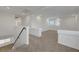 Upstairs loft featuring neutral carpet, natural light, and staircase with modern railing at 10325 Quartz Reef Ct, Las Vegas, NV 89141