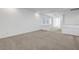 Spacious loft with neutral carpet and white walls and staircase at 10325 Quartz Reef Ct, Las Vegas, NV 89141