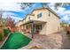 Backyard with covered patio, artificial turf, paver patio, grill and outdoor furniture at 10623 Kearney Mountain Ave, Las Vegas, NV 89166