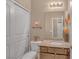 Cozy bathroom features a granite countertop, decorative mirror and art, plus a toilet and plant at 10623 Kearney Mountain Ave, Las Vegas, NV 89166