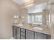 Bright bathroom with double sinks, granite countertops, a soaking tub, and a separate glass-enclosed shower at 10623 Kearney Mountain Ave, Las Vegas, NV 89166