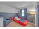 room design with 'Lightning McQueen' race car bed, half blue wall, curtains, and a seat at 10623 Kearney Mountain Ave, Las Vegas, NV 89166