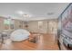 Large bonus room with wood laminate flooring, a projector screen, and an exercise area next to a cozy beanbag chair at 10623 Kearney Mountain Ave, Las Vegas, NV 89166
