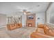 Cozy living room with leather sofas, a brick fireplace, and a ceiling fan creating a welcoming atmosphere at 10623 Kearney Mountain Ave, Las Vegas, NV 89166