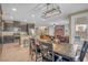 Open-concept living space with a dining table, living room, and a well-equipped kitchen creating a functional layout at 10623 Kearney Mountain Ave, Las Vegas, NV 89166