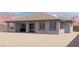 Back of home featuring a covered patio, dark framed windows, and neutral paint at 1860 Old West Ave, Pahrump, NV 89048