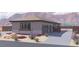 A single story home featuring a desert landscape, gray color scheme, and a gated drive at 1860 Old West Ave, Pahrump, NV 89048