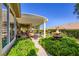 Spacious back patio featuring a covered area with outdoor seating, a water fountain, and well-manicured landscaping at 1897 Holdenville St, Henderson, NV 89052