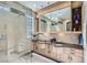 Modern bathroom featuring a glass-enclosed shower, double vanity, and contemporary design at 1897 Holdenville St, Henderson, NV 89052