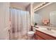 Cozy bathroom with shower and tub featuring a light wood vanity, white accents, and decorative towels at 1897 Holdenville St, Henderson, NV 89052