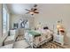 A cozy bedroom features a decorative iron bed frame, bright light, and nice window shutters at 1897 Holdenville St, Henderson, NV 89052