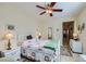 A cozy bedroom features a decorative iron bed frame, bright light, and neutral wall color at 1897 Holdenville St, Henderson, NV 89052