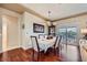 Elegant dining room featuring hardwood floors, modern lighting, and sliding glass doors to the outdoor area at 1897 Holdenville St, Henderson, NV 89052