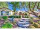 Inviting single-story home with desert landscaping, a decorative gate, and a stone-accented facade at 1897 Holdenville St, Henderson, NV 89052