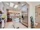 Open kitchen with stainless steel appliances, island, and views of the dining area at 1897 Holdenville St, Henderson, NV 89052
