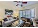 Bright living room featuring a ceiling fan, neutral walls, bay window, and comfortable seating area for relaxation at 1897 Holdenville St, Henderson, NV 89052