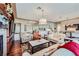 Bright and open living room with hardwood floors, fireplace, and seamless flow to dining and kitchen areas at 1897 Holdenville St, Henderson, NV 89052