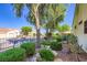 Landscaped side yard with mature trees, lush greenery, and decorative rocks, offering a tranquil outdoor space at 1897 Holdenville St, Henderson, NV 89052