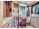 A luxury walk-in closet with beautiful wood finishes, lots of storage, vanity, and a patterned floor at 1897 Holdenville St, Henderson, NV 89052
