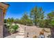 Backyard featuring desert landscaping, a fountain, and an iron fence at 2016 Biloxi Pass, Henderson, NV 89052