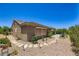 Private backyard showing a stone-paved path, desert landscaping, and an outdoor living area at 2016 Biloxi Pass, Henderson, NV 89052