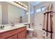 Well-lit bathroom featuring cherry cabinets, tiled floors, and a shower-tub combination at 2016 Biloxi Pass, Henderson, NV 89052