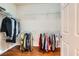 Walk-in closet with wood floor and built-in shelving for optimal storage solutions at 2016 Biloxi Pass, Henderson, NV 89052