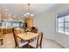 Cozy dining area featuring tile flooring, a chandelier, and views into the kitchen and backyard at 2016 Biloxi Pass, Henderson, NV 89052