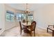 Bright dining area featuring tile floors, large windows, and a chandelier at 2016 Biloxi Pass, Henderson, NV 89052