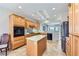Sunlit kitchen features wood cabinets, stainless appliances, a center island, and tile flooring at 2016 Biloxi Pass, Henderson, NV 89052