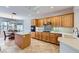 Bright kitchen features wood cabinets, stainless appliances, tile backsplash, and a center island at 2016 Biloxi Pass, Henderson, NV 89052