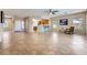 Open-concept living room featuring tile flooring, neutral paint colors, and a view of the kitchen and dining area at 2016 Biloxi Pass, Henderson, NV 89052