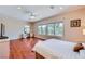 Bright main bedroom with wood floors, ceiling fan, and backyard views at 2016 Biloxi Pass, Henderson, NV 89052