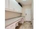 Utility room including ample storage cabinets, countertop space, and tile flooring at 2016 Biloxi Pass, Henderson, NV 89052