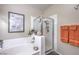 Bathroom featuring a bathtub and a shower with glass doors and tiled walls at 2050 W Warm Springs Rd # 1923, Henderson, NV 89014
