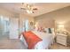 Bright bedroom featuring neutral decor, a ceiling fan, and doorways to the bathroom and closet at 2050 W Warm Springs Rd # 1923, Henderson, NV 89014