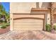 Exterior shot of a two-car garage door with brick-paved driveway at 2050 W Warm Springs Rd # 1923, Henderson, NV 89014