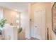 Bright hallway featuring plants, three square windows, and a door at 2050 W Warm Springs Rd # 1923, Henderson, NV 89014
