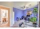 Office space featuring two desks, a ceiling fan, a large plant, and purple walls at 2050 W Warm Springs Rd # 1923, Henderson, NV 89014