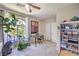 Bright office space featuring a potted plant near a large window, desk, and shelving unit at 2050 W Warm Springs Rd # 1923, Henderson, NV 89014