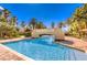 Beautiful view of a community swimming pool with a bridge under a clear blue sky at 2050 W Warm Springs Rd # 1923, Henderson, NV 89014