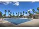 Community tennis courts bordered by palm trees on a bright day at 2050 W Warm Springs Rd # 1923, Henderson, NV 89014